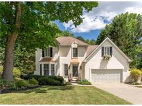Charming two-story traditional home featuring an attached garage, manicured lawn, and mature trees in a desirable neighborhood at 988 Gentry Sw Ln, Marietta, GA 30064