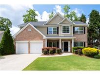 Charming two-story brick home with a well-manicured lawn, two-car garage, and inviting front entrance at 2580 Glaramara Ter, Cumming, GA 30041