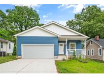 Charming blue home with a welcoming front porch and a two-car attached garage at 1924 Browns Mill Se Rd, Atlanta, GA 30315