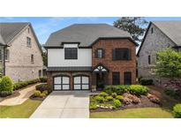 Beautiful two-story home with brick accents, two-car garage, and manicured landscaping at 4900 Kentwood Dr, Marietta, GA 30068