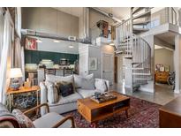 Stylish open-concept living room featuring a modern kitchen, cozy seating, and a striking spiral staircase at 791 Wylie Se St # 912, Atlanta, GA 30316