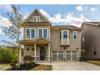 Charming two-story home features a manicured lawn and a welcoming covered front porch at 2080 Abbey Rd, Roswell, GA 30076
