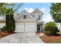 Charming two-story home with a two car garage and manicured landscaping and inviting curb appeal at 212 Regent Sq, Woodstock, GA 30188