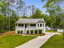 Charming single-story home with well-manicured lawn and inviting front porch at 1094 Plantation Ct, Villa Rica, GA 30180