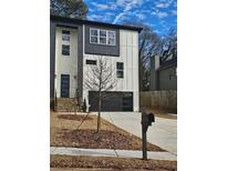 Modern two-story home with black trimmed windows and a black garage door at 503 Glendale Rd, Scottdale, GA 30079