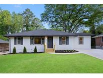 Charming ranch-style home featuring a well-manicured lawn, dark shutters, and a freshly painted exterior at 2805 Long Way, Decatur, GA 30032
