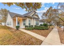 Charming single-story home with manicured landscaping and inviting front porch at 5863 Landers Loop, Fairburn, GA 30213