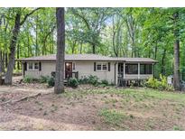 Charming single-story house featuring a screened in back porch, surrounded by lush trees at 103 Campground School Rd, Dallas, GA 30157