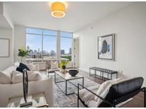 Bright living room with floor to ceiling windows and a beautiful city view at 1820 Peachtree Nw St # 1110, Atlanta, GA 30309