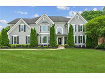 Beautiful two-story home with a manicured lawn, mature trees, and a traditional design at 110 Keswick Way, Alpharetta, GA 30022