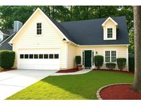 Charming single Gathering home showcasing a well-manicured lawn and an attached two-car garage at 3315 Haverhill Rowe, Lawrenceville, GA 30044