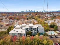 Stunning aerial view of modern apartments with a pool and city skyline in the background at 130 Arizona Ne Ave # 104, Atlanta, GA 30307