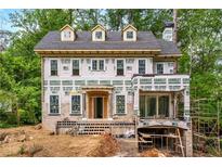New construction featuring a brick and hardie board exterior with dormers and a covered front entry at 1176 Lullwater Ne Rd, Atlanta, GA 30307