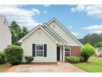 Charming single-story home with brick and siding, featuring a well-manicured lawn and inviting curb appeal at 220 Turnstone Rd, Stockbridge, GA 30281