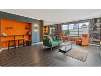 Cozy living room features a bar area, exposed brick, and lots of natural light at 3481 Lakeside #901 Ne Dr, Atlanta, GA 30326