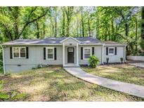 Charming single-story home with a well-manicured front yard and a welcoming entrance at 3735 Boulder Park Sw Dr, Atlanta, GA 30331