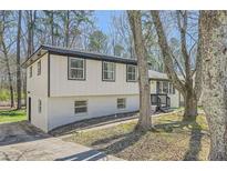 Charming home with brick and siding and large trees in the front yard at 6552 King George Way, Morrow, GA 30260