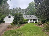 Charming home with a lush front lawn and attached garage, surrounded by mature trees at 3 Perthshire Dr, Peachtree City, GA 30269