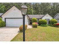Charming one-story home with a manicured lawn, mature shrubs, and two-car garage at 3130 Jorden Crest Ct, Lawrenceville, GA 30044