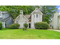 Charming two-story home with a lush green lawn and well-maintained landscaping at 76 Burbank Dr, Atlanta, GA 30314
