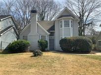 Charming two-story home featuring a well-maintained front yard and brick chimney at 76 Burbank Dr, Atlanta, GA 30314
