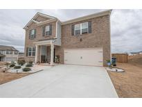 Traditional two-story brick home with a two-car garage and well-maintained landscaping at 2718 Serena Way, Atlanta, GA 30331