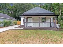 Charming home featuring a cozy front porch and freshly cut lawn at 1055 Mayson Turner Nw Rd, Atlanta, GA 30314