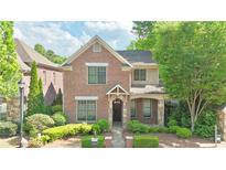 Charming two-story brick home with well-manicured landscaping and inviting entrance, nestled among mature trees at 2080 Village Station Xing, Smyrna, GA 30080