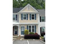 Charming townhome with blue shutters and manicured landscaping for a cozy curb appeal at 211 Buckland Dr, Alpharetta, GA 30022