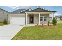 Charming single Gathering home featuring light brick, white trim, and a well manicured lawn at 6908 Winchester Pl, Fairburn, GA 30213