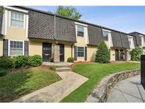 Charming townhouse featuring a well-manicured lawn and a welcoming walkway to the front door at 6906 Park Ave, Atlanta, GA 30342