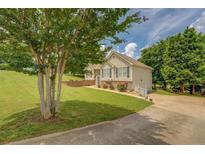 Inviting home with well-manicured lawn, mature trees, and a charming facade, perfect for suburban living at 75 Puppy Chase, Social Circle, GA 30025