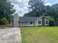 Charming single-story home with a well-maintained lawn and classic architectural details at 8922 Gatewood Cir, Jonesboro, GA 30238