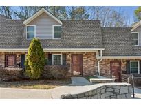 Traditional brick townhome with well-maintained landscaping and charming front entryway at 3135 Reeves Se St, Smyrna, GA 30080
