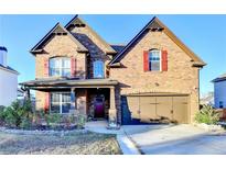 Charming two-story brick home with a well-manicured lawn and a two-car garage at 3431-0 Tioga Lake Cv, Lawrenceville, GA 30044