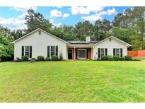 Charming single-story home with a well-maintained lawn and mature trees at 425 Charlyne Way, Dacula, GA 30019