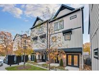 Beautiful townhouse with light colored siding, black trim, and manicured landscaping at 2587 Ocean Walk Nw Dr, Atlanta, GA 30318