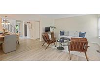 Bright living room features wood flooring, a modern couch, and cozy armchairs at 2117 Bucktrout Pl, Dunwoody, GA 30338