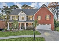 Charming two-story home with a well-manicured lawn and a two-car garage at 1558 Park Knoll Trl, Lawrenceville, GA 30043