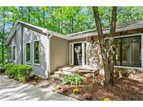 Charming home featuring a stone accent wall and well-maintained landscaping around the welcoming front entrance at 4700 Township Walk, Marietta, GA 30066
