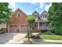 Charming brick home featuring a two-car garage and well-maintained landscaping at 116 Patrick Way, Marietta, GA 30064