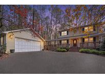 Charming two-story home featuring a welcoming front porch, a spacious driveway and attached garage at 4211 Burnt Hickory Nw Rd, Marietta, GA 30064