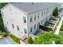 Beautiful townhome exterior featuring brick facade, private patios, and lush landscaping at 3481 Landen Pine Ne Ct, Atlanta, GA 30305