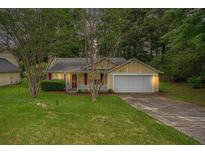 Charming single-Gathering home with yellow siding, red shutters, well-maintained lawn, and attached garage at 2631 Rolling Hills Way, Conyers, GA 30094