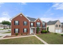 Traditional brick home with black shutters, manicured lawn, and a welcoming entryway at 4699 Price St, Forest Park, GA 30297