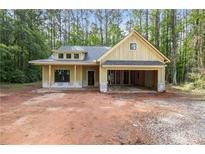 Charming single-story home featuring an attached two car garage and classic architectural details at 48 Paschal St, Temple, GA 30179