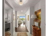 Bright hallway featuring hardwood floors, elegant lighting, and seamless transition to the living area with a stunning view at 700 Park Regency Ne Pl # 1407, Atlanta, GA 30326