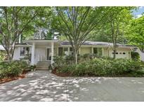 Charming ranch home with mature landscaping and a welcoming front entrance at 1410 Lively Ridge Ne Rd, Atlanta, GA 30329