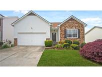 Charming single-Gathering home features a stone facade, well-manicured lawn, and an attached two-car garage at 1544 Overview Cir, Lawrenceville, GA 30044