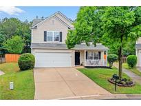 Charming two-story home with a well-manicured lawn and inviting front porch at 408 Sam Cobb Ct, Woodstock, GA 30188